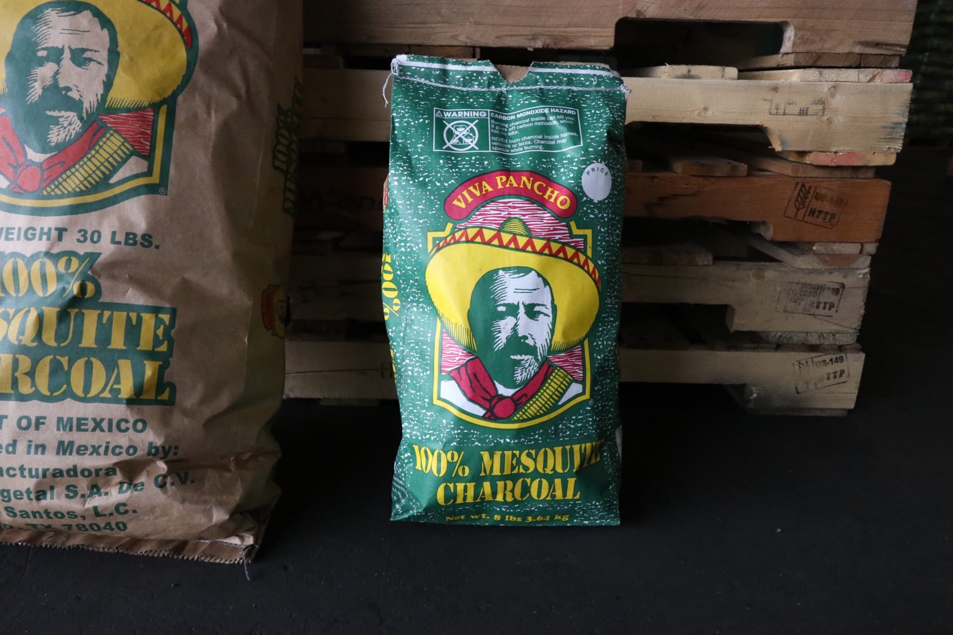 30 lb and 8 lb mesquite charcoal bags with pallets